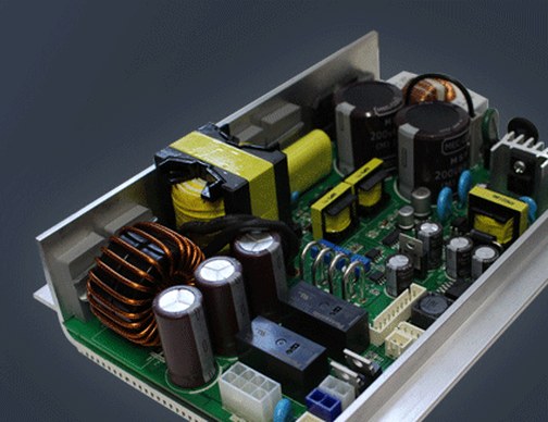 Open SMPS power supply circuit board with capacitors and toroidal inductors