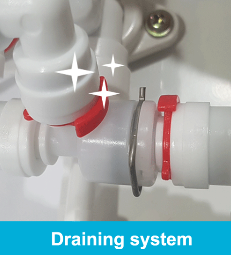 Prime Water automatic drainage system — close-up of the red drain valve and white piping